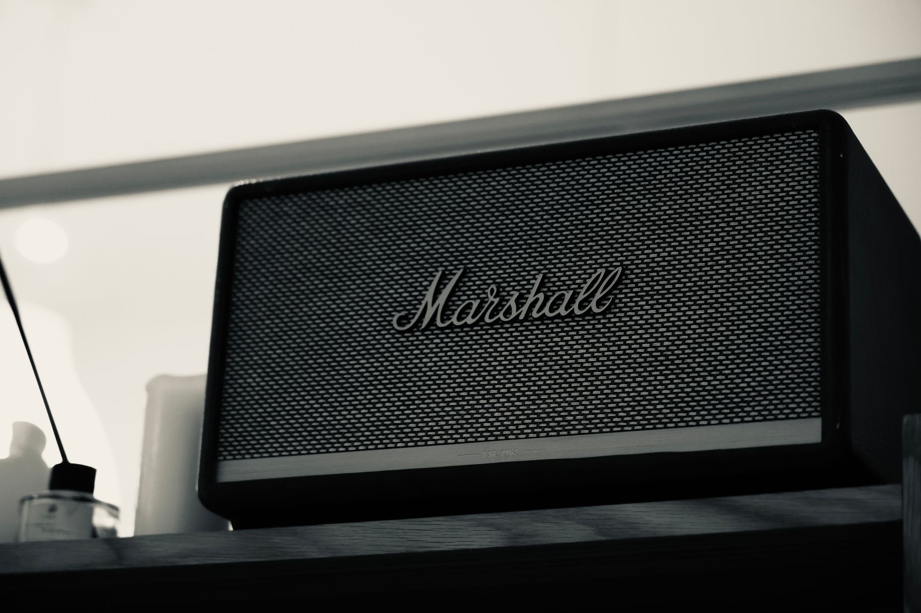 Speaker enclosure on a dark wooden shelf showing craftsmanship and build quality