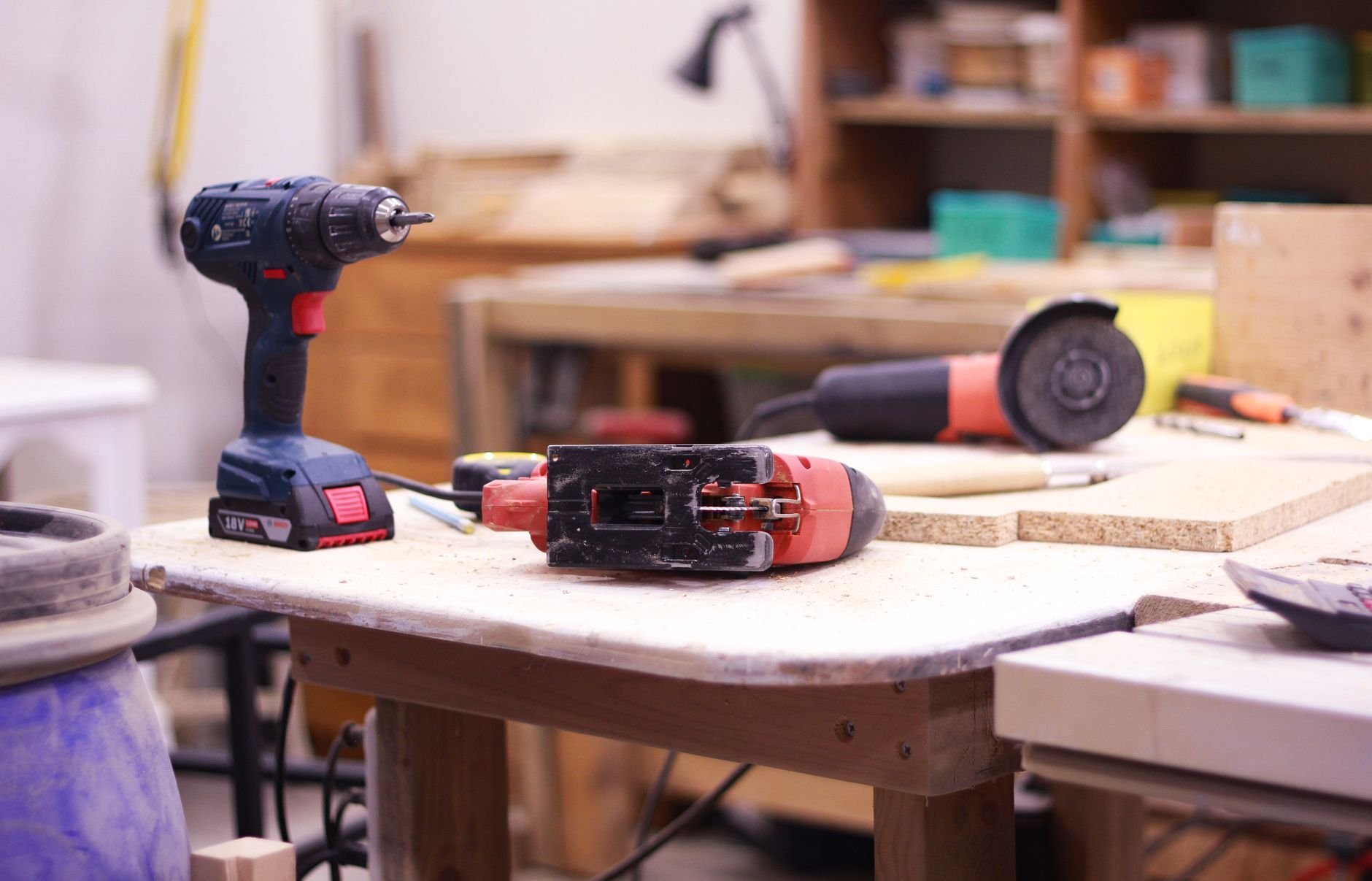 Close-up of woodworking tools on a workshop table used for building subwoofer enclosures